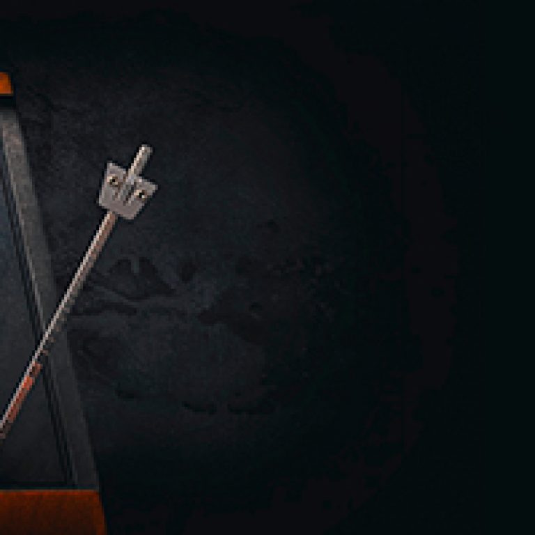 Vintage metronome on dark background. Low key image.