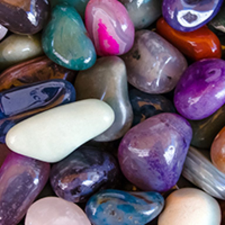 Happiness stones. Full frame colorful polished stones background. Close-up.